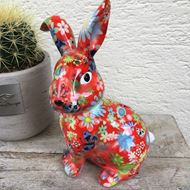 Bild von Fröhlicher Keramik-Hase in rot mit Blumenmotiv